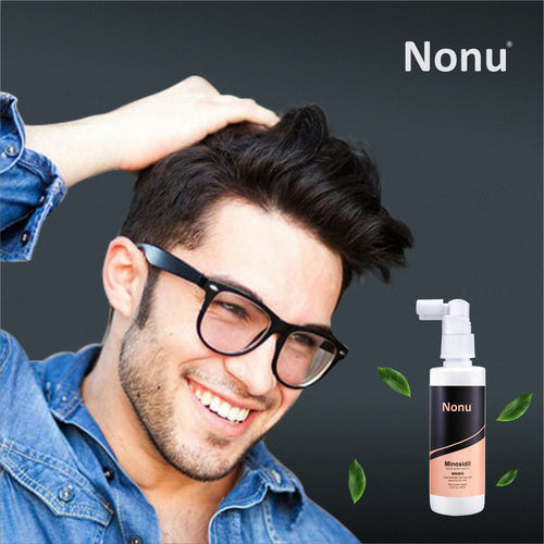 Smiling man with healthy hair beside Nonu Minoxidil spray for hair regrowth and hair loss treatment.
