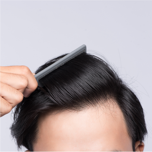Person combing smooth, healthy black hair to maintain shine and reduce hair breakage