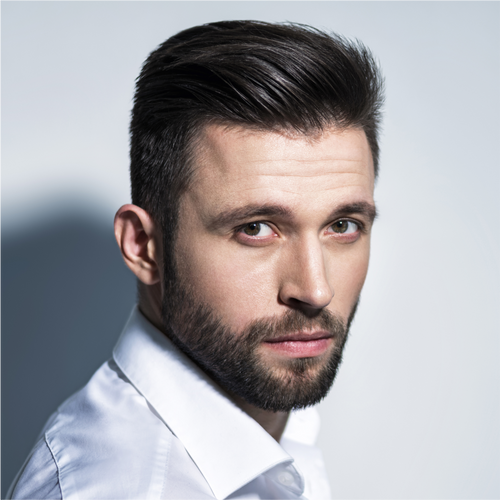 Portrait of a man with thick, neatly styled black hair and a well-groomed beard.